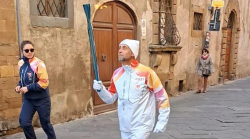 L'ingegnere tedoforo Caleri dopo aver portato la torcia delle Olimpiadi invernali dona la divisa ufficiale al suo Comune